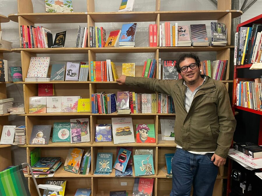 O livreiro Bruno Eliezer, da Livraria Ponta de Lança, no estande d'A Feira do Livro | © Guilherme Sobota / PublishNews O livreiro Bruno Eliezer, da Livraria Ponta de Lança, no estande d'A Feira do Livro | © Guilherme Sobota / PublishNews
